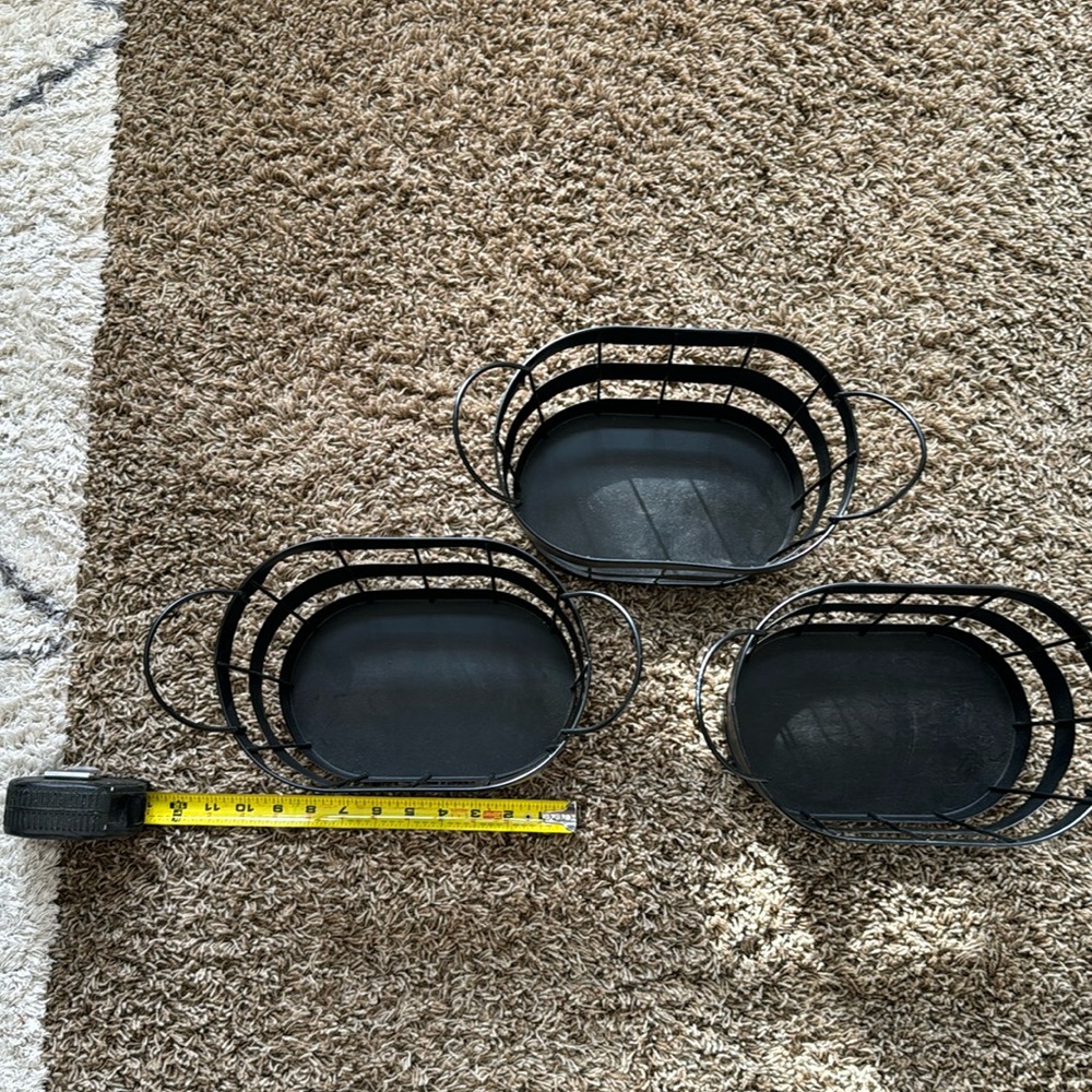Three black metal bins